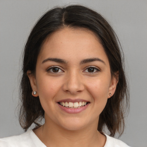 Joyful white young-adult female with medium  brown hair and brown eyes