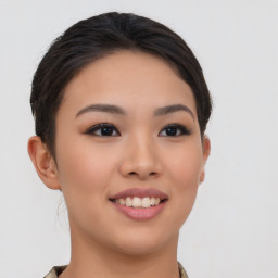 Joyful asian young-adult female with short  brown hair and brown eyes