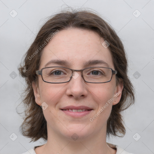 Joyful white adult female with medium  brown hair and grey eyes