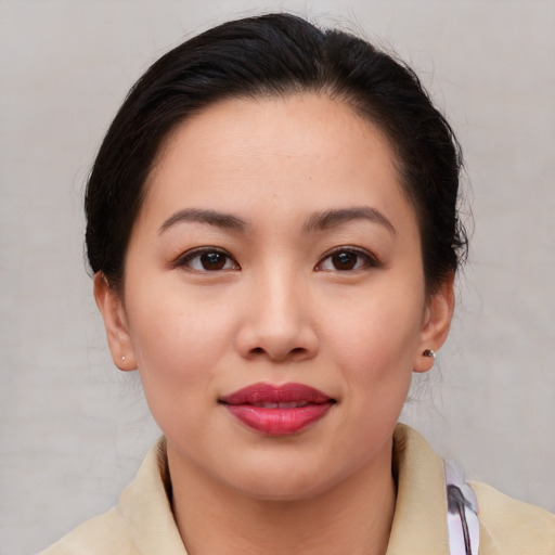 Joyful asian young-adult female with medium  brown hair and brown eyes