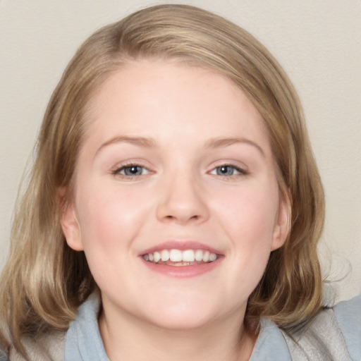 Joyful white young-adult female with medium  brown hair and blue eyes