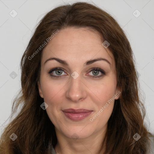 Joyful white adult female with long  brown hair and brown eyes