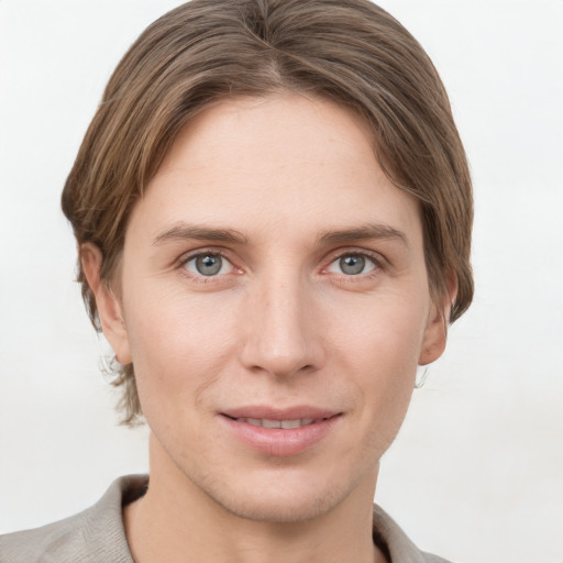 Joyful white young-adult female with short  brown hair and grey eyes