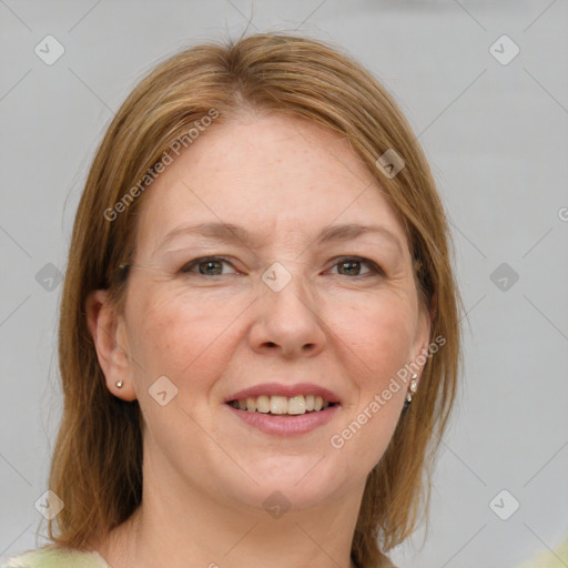 Joyful white adult female with medium  brown hair and green eyes