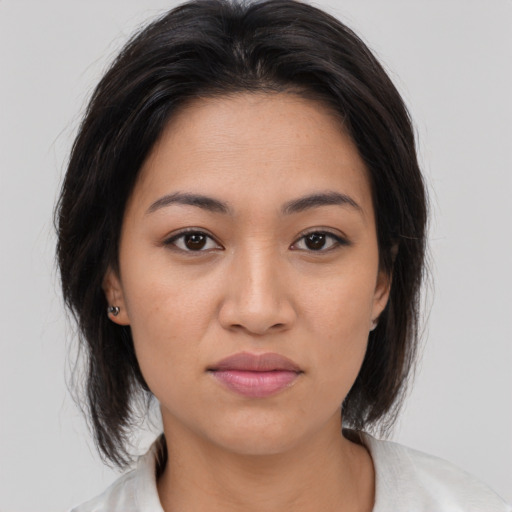 Joyful asian young-adult female with medium  brown hair and brown eyes