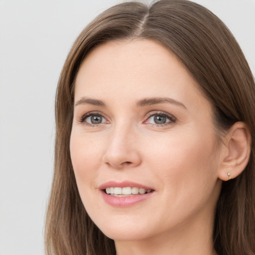 Joyful white young-adult female with long  brown hair and grey eyes