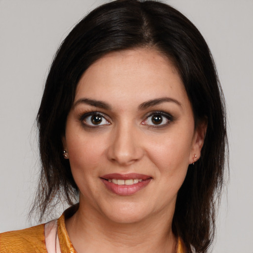 Joyful white young-adult female with medium  brown hair and brown eyes