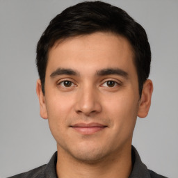 Joyful white young-adult male with short  black hair and brown eyes