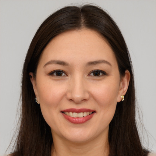 Joyful white young-adult female with long  brown hair and brown eyes