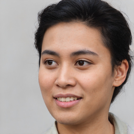 Joyful asian young-adult female with short  brown hair and brown eyes