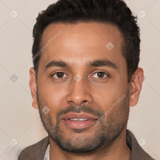 Joyful black young-adult male with short  black hair and brown eyes