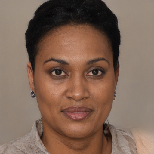 Joyful black young-adult female with short  black hair and brown eyes