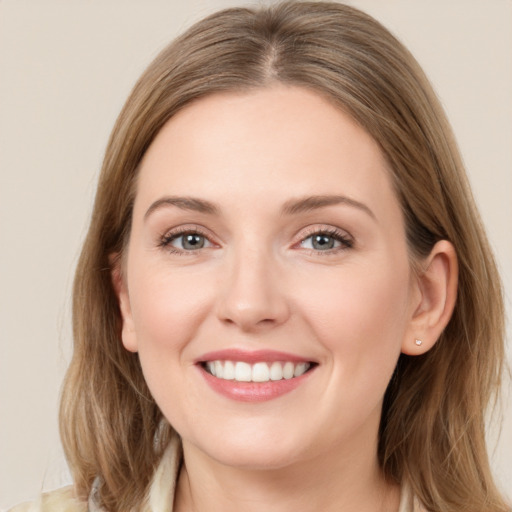 Joyful white young-adult female with long  brown hair and grey eyes