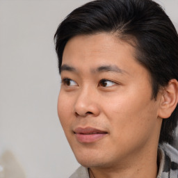 Joyful asian young-adult male with short  brown hair and brown eyes