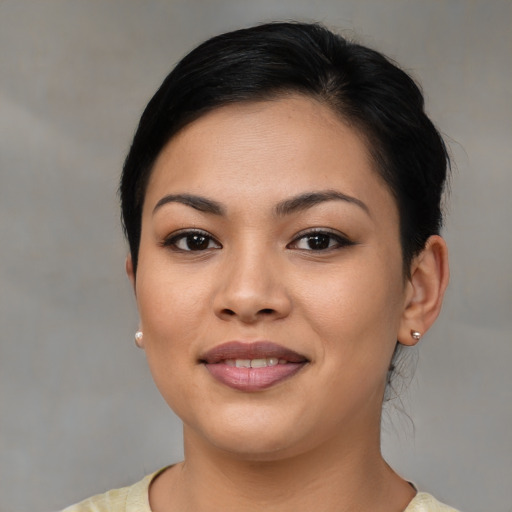 Joyful latino young-adult female with medium  brown hair and brown eyes