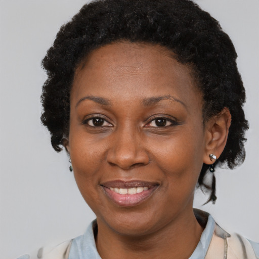 Joyful latino adult female with short  black hair and brown eyes