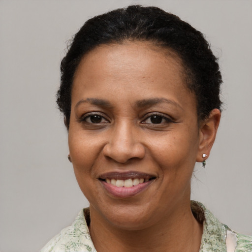 Joyful black adult female with short  brown hair and brown eyes