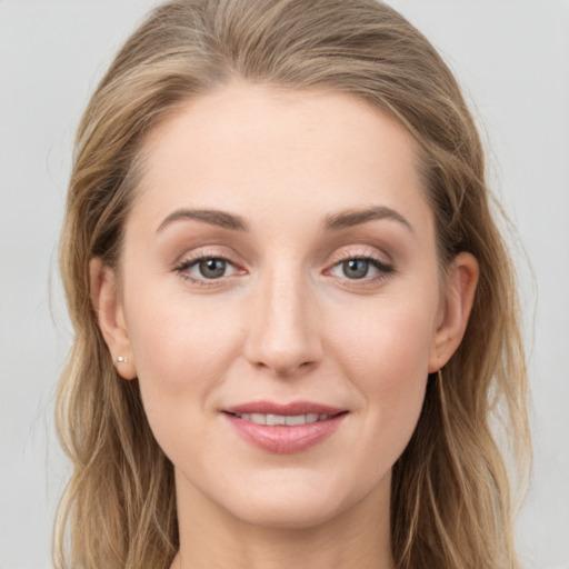 Joyful white young-adult female with long  brown hair and grey eyes