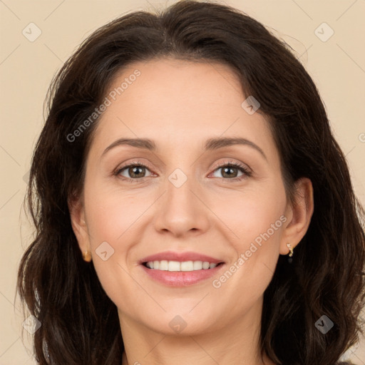 Joyful white adult female with long  brown hair and brown eyes