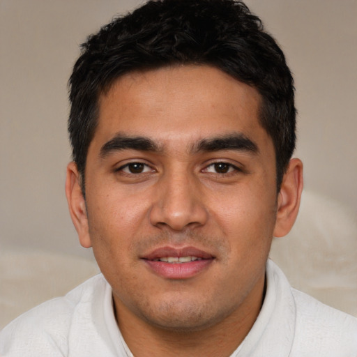Joyful white young-adult male with short  black hair and brown eyes