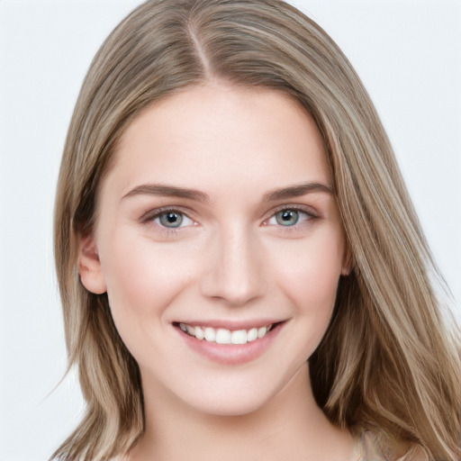 Joyful white young-adult female with long  brown hair and grey eyes