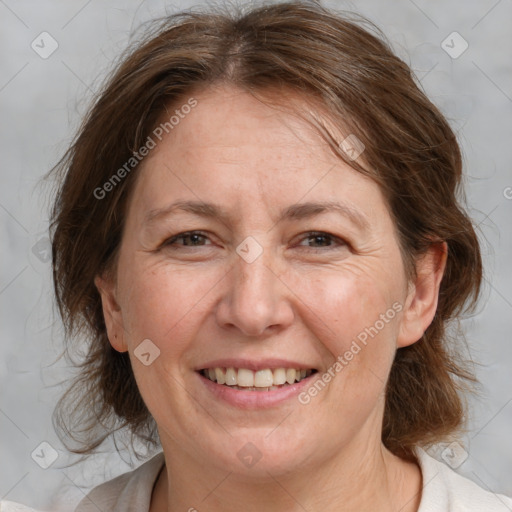 Joyful white adult female with medium  brown hair and brown eyes