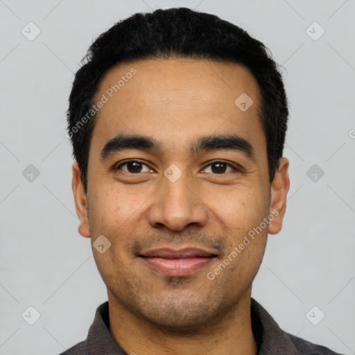 Joyful latino young-adult male with short  black hair and brown eyes