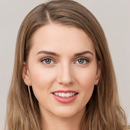 Joyful white young-adult female with long  brown hair and grey eyes