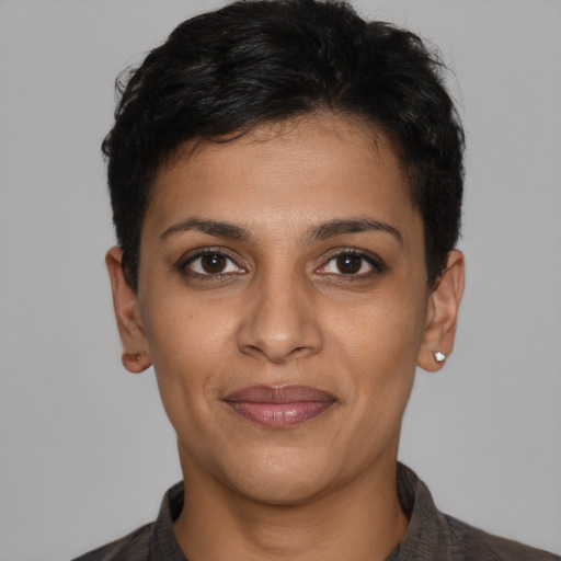Joyful latino young-adult female with short  black hair and brown eyes