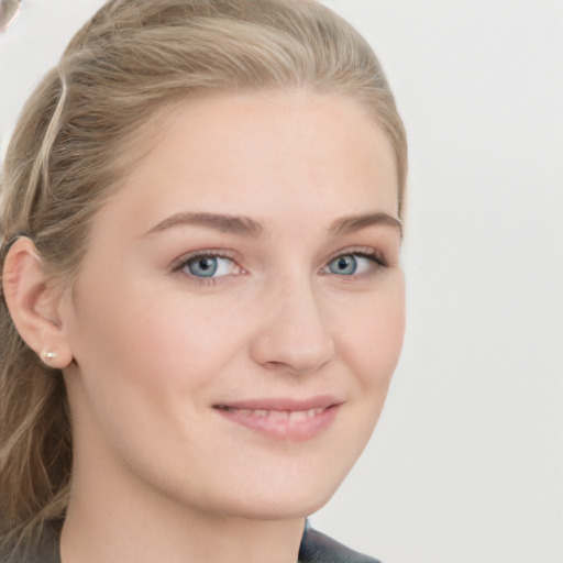 Joyful white young-adult female with long  brown hair and blue eyes