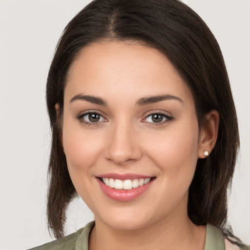 Joyful white young-adult female with medium  brown hair and brown eyes