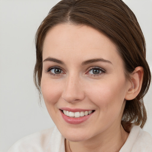 Joyful white young-adult female with medium  brown hair and brown eyes