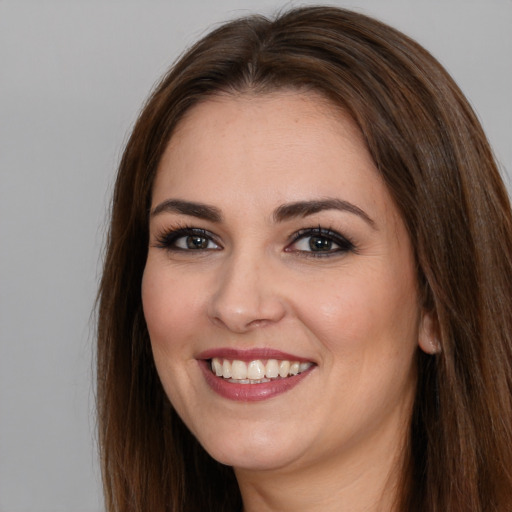 Joyful white young-adult female with long  brown hair and brown eyes