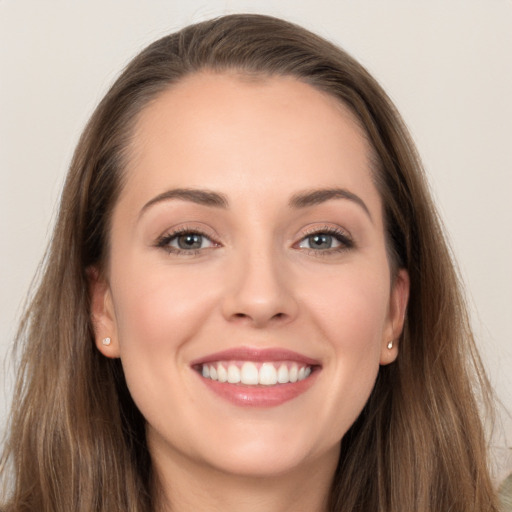 Joyful white young-adult female with long  brown hair and grey eyes