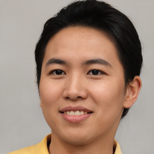 Joyful asian young-adult male with medium  brown hair and brown eyes