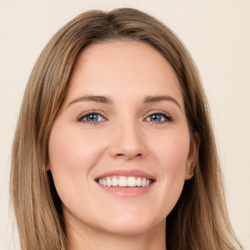 Joyful white young-adult female with long  brown hair and green eyes