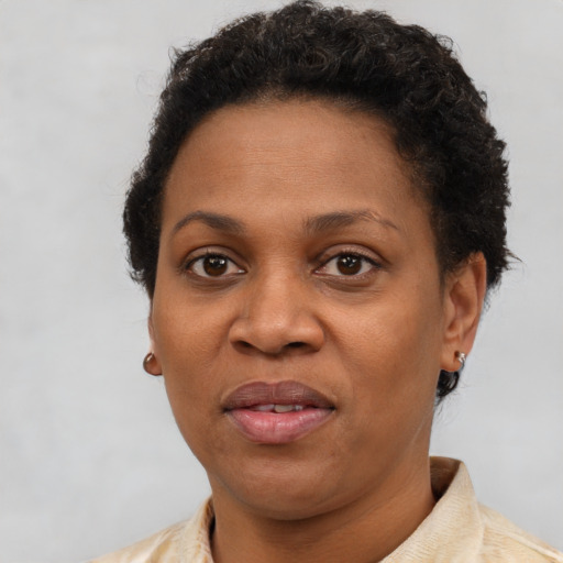 Joyful black adult female with short  brown hair and brown eyes