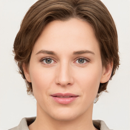 Joyful white young-adult female with medium  brown hair and grey eyes