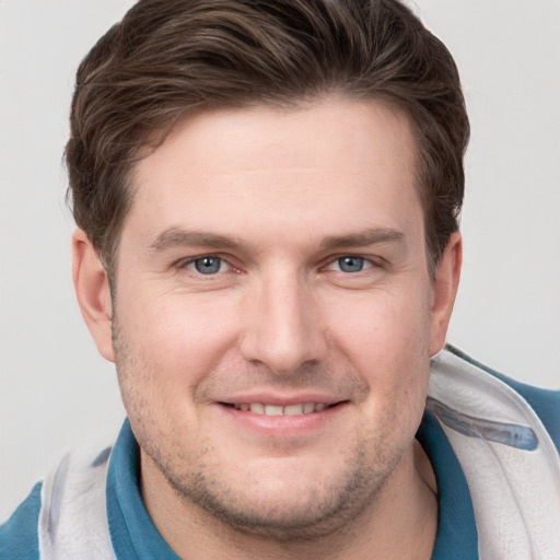 Joyful white young-adult male with short  brown hair and grey eyes