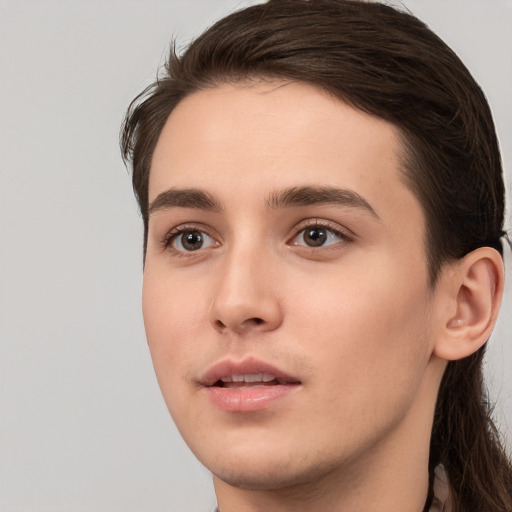 Neutral white young-adult male with long  brown hair and brown eyes