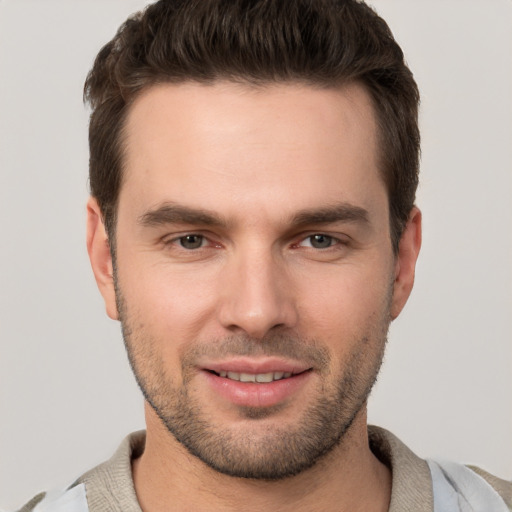 Joyful white young-adult male with short  brown hair and brown eyes