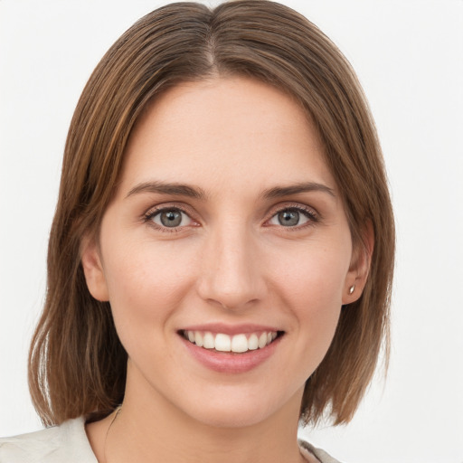 Joyful white young-adult female with medium  brown hair and green eyes