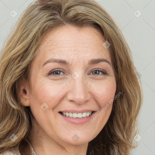 Joyful white adult female with long  brown hair and brown eyes