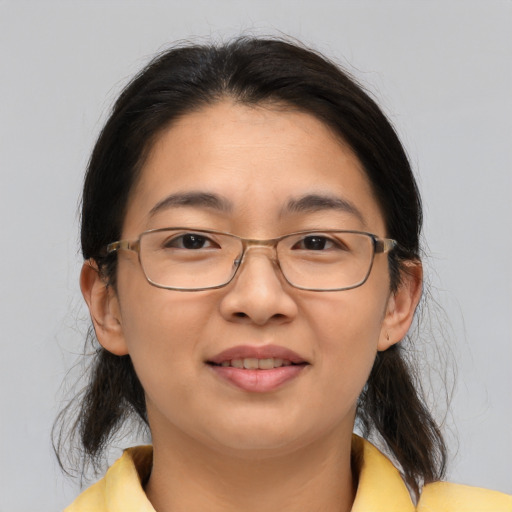 Joyful asian adult female with medium  brown hair and brown eyes