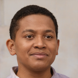 Joyful latino young-adult male with short  brown hair and brown eyes