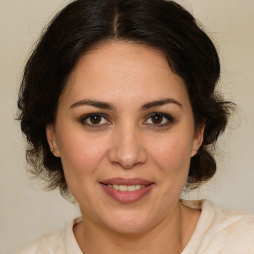 Joyful white adult female with medium  brown hair and brown eyes