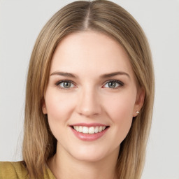 Joyful white young-adult female with long  brown hair and green eyes