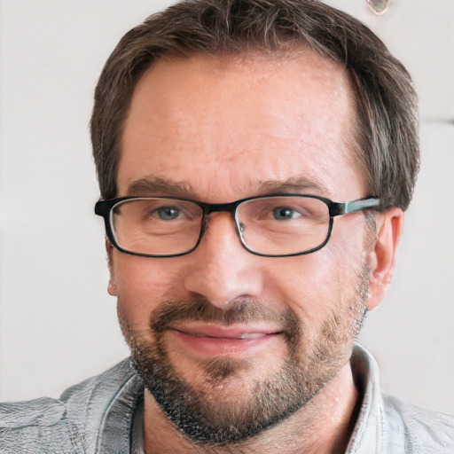 Joyful white adult male with short  brown hair and blue eyes