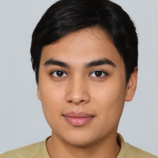 Joyful asian young-adult male with short  brown hair and brown eyes