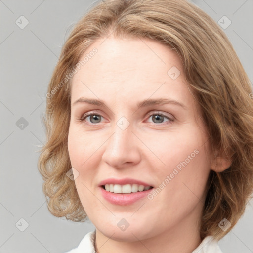 Joyful white young-adult female with medium  brown hair and green eyes